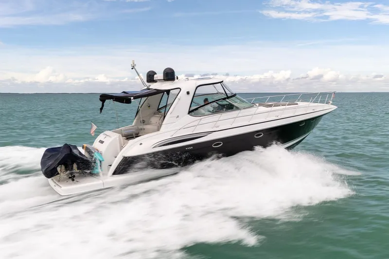 Slide: The Image of 2005 Formula 48 Yacht cruising on open water under a clear sky. - 12