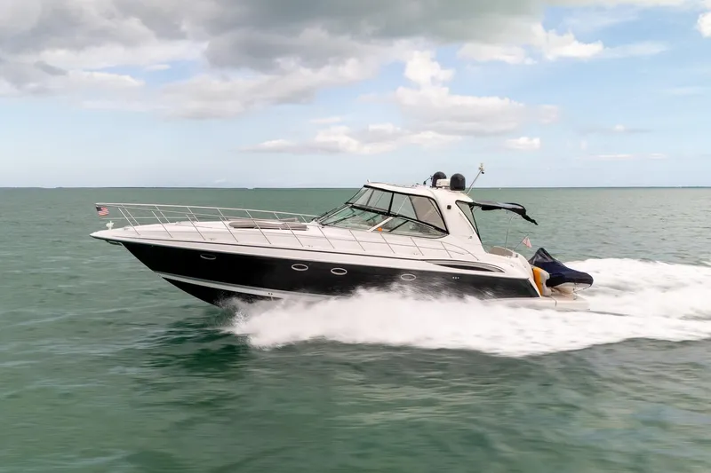 Slide: The Image of 2005 Formula 48 Yacht cruising on open water under cloudy skies. - 13