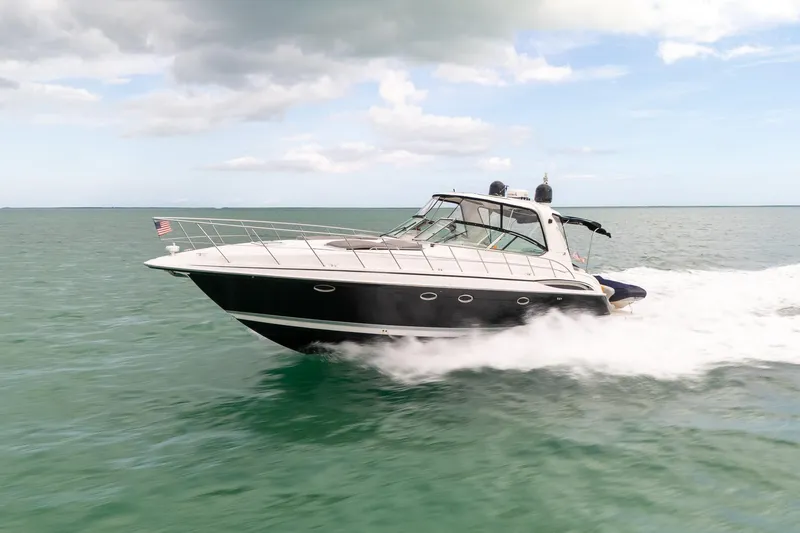 Slide: The Image of 2005 Formula 48 Yacht cruising on open water under a partly cloudy sky. - 14