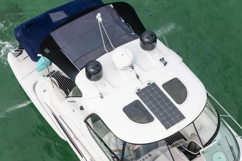 Slide: The Image of 2005 Formula 48 Yacht with solar panels on the roof, cruising in green waters. - 2
