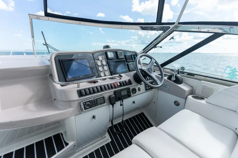 Slide: The Image of Helm of 2005 Formula 48 Yacht with modern navigation equipment and ocean view. - 24