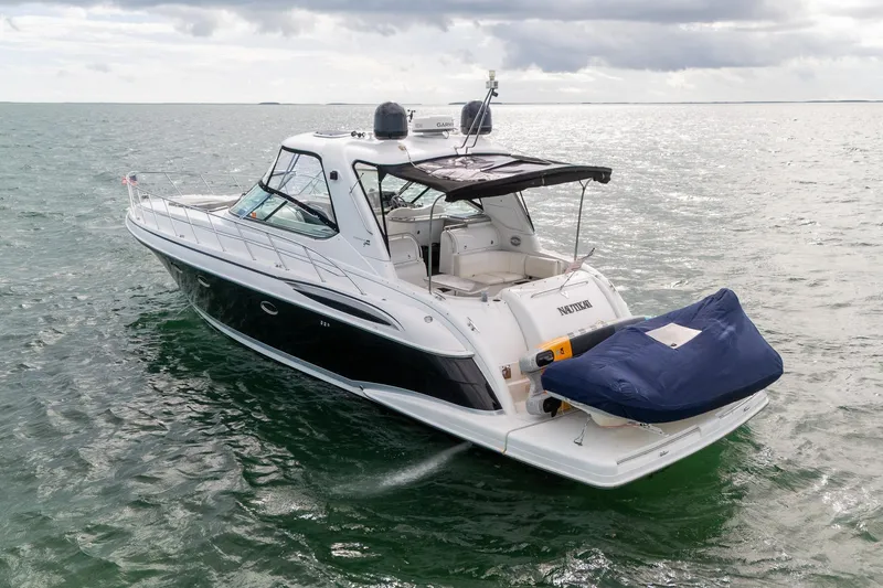 Slide: The Image of 2005 Formula 48 Yacht cruising on open water under cloudy skies. - 4