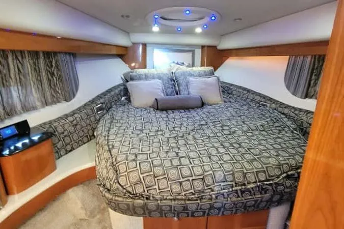 Slide: The Image of Luxurious interior of a 2005 Formula 48 Yacht with elegant bedding and ambient lighting. - 44