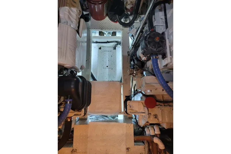 Slide: The Image of Engine room of a 2005 Formula 48 Yacht, showcasing mechanical components and piping. - 46