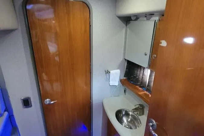 Slide: The Image of Interior of 2005 Formula 48 Yacht bathroom with wooden door and compact sink. - 48