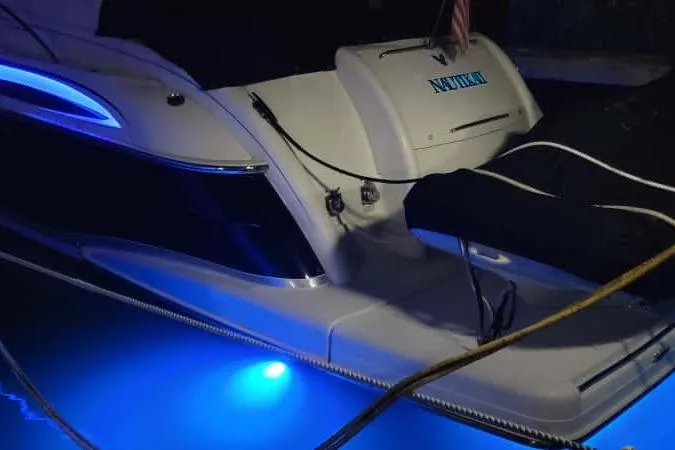 Slide: The Image of 2005 Formula 48 Yacht with blue underwater lights at night. - 51