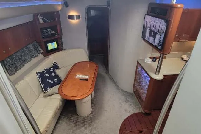 Slide: The Image of 2005 Formula 48 Yacht interior with cozy seating, wooden table, and entertainment area. - 53