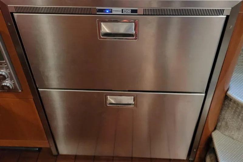 Slide: The Image of Stainless steel refrigerator drawers on 2005 Formula 48 Yacht interior. - 54