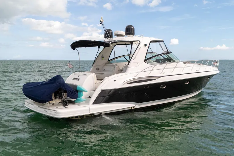 Slide: The Image of 2005 Formula 48 Yacht cruising on open water under a clear sky. - 6