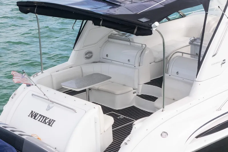 Slide: The Image of 2005 Formula 48 Yacht with spacious deck and seating, docked on calm water. - 7