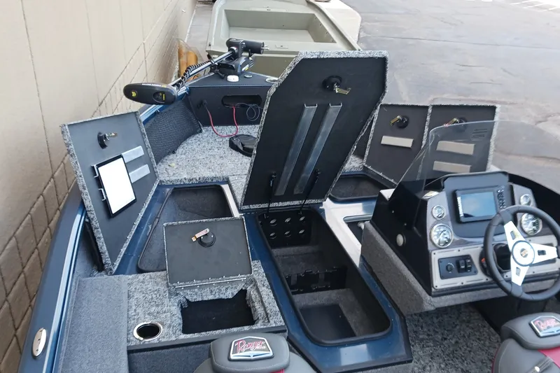 Slide: The Image of 2026 Ranger VS1882SC Reata boat interior with open storage compartments and control panel. - 6