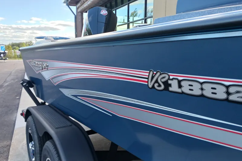 Slide: The Image of 2026 Ranger VS1882SC Reata boat with sleek blue design and red accents. - 2