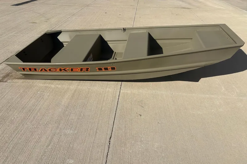 Slide: The Image of 2026 Tracker Grizzly 10 Jon boat on concrete surface, side view. - 2
