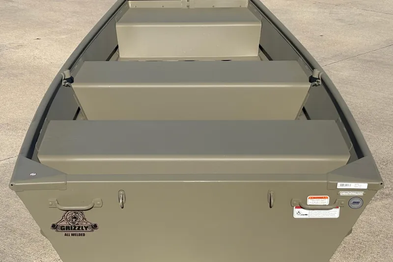Slide: The Image of 2026 Tracker Grizzly 10 Jon boat, all-welded design, viewed from above on concrete surface. - 3