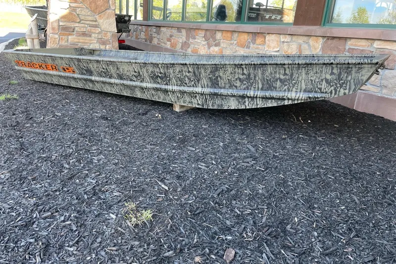 The Image of 2026 Tracker Grizzly 15 Jon boat with camouflage design, displayed outdoors. - 0