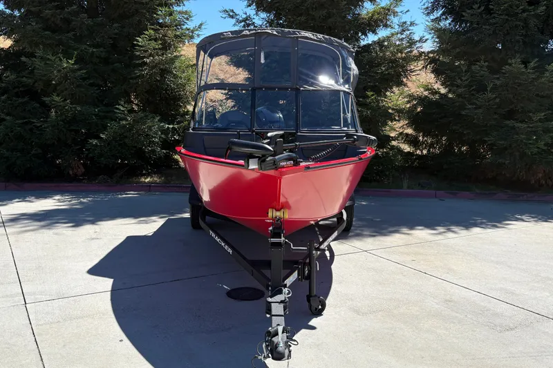 Slide: The Image of 2026 Tracker Pro Guide V-16 WT boat on trailer, parked outdoors. - 3