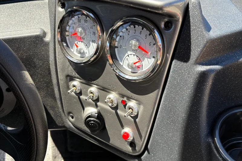 Slide: The Image of Dashboard of 2026 Tracker Pro Guide V-16 WT with gauges and switches. - 19