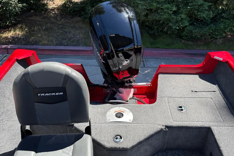 Slide: The Image of 2026 Tracker Pro Guide V-16 WT boat interior with motor and seating. - 26
