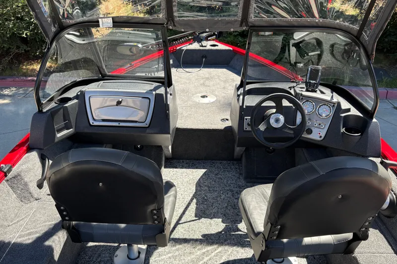 Slide: The Image of Interior of 2026 Tracker Pro Guide V-16 WT boat with dual seats and dashboard controls. - 16