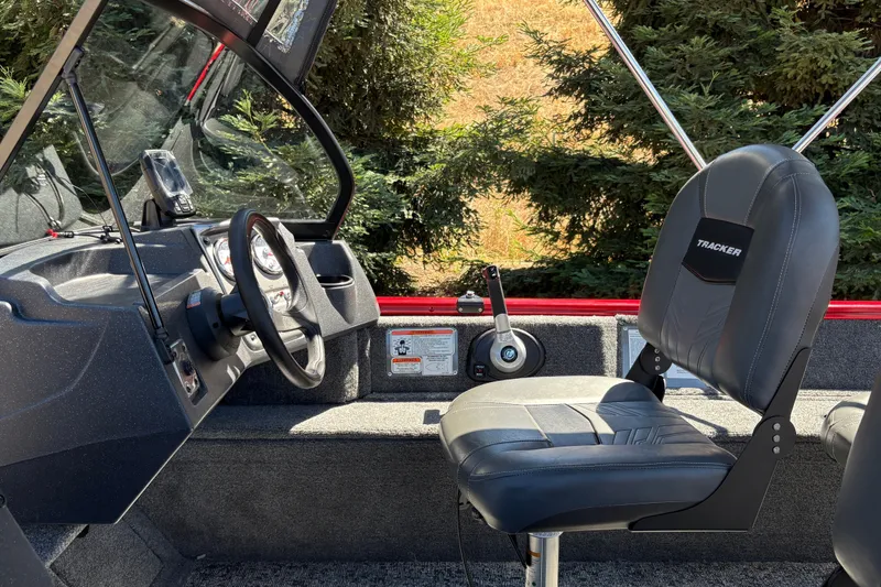 Slide: The Image of 2026 Tracker Pro Guide V-16 WT boat interior with steering wheel and seating. - 27