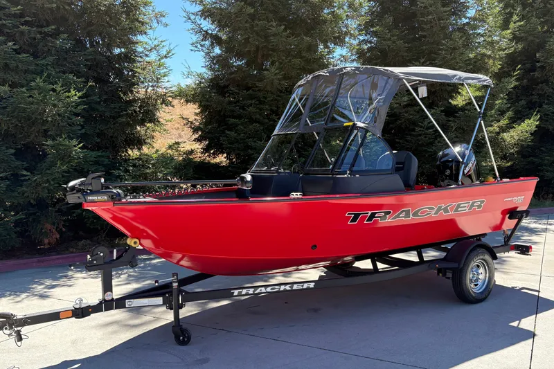 Slide: The Image of 2026 Tracker Pro Guide V-16 WT boat, red, on trailer, parked outdoors. - 5