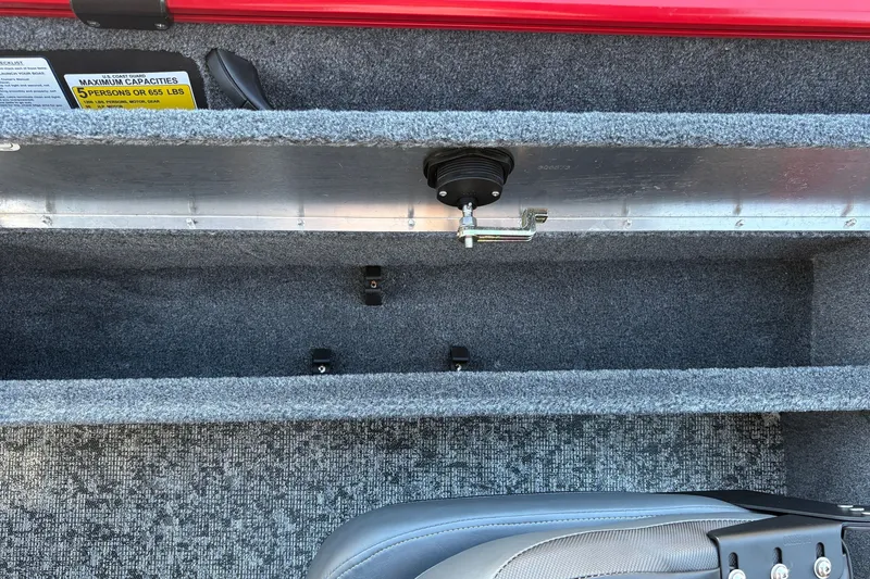 Slide: The Image of 2026 Tracker Pro Guide V-16 WT boat interior storage compartment with capacity label. - 28