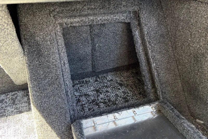 Slide: The Image of Carpeted storage compartment in 2026 Tracker Pro Guide V-16 WT boat interior. - 31