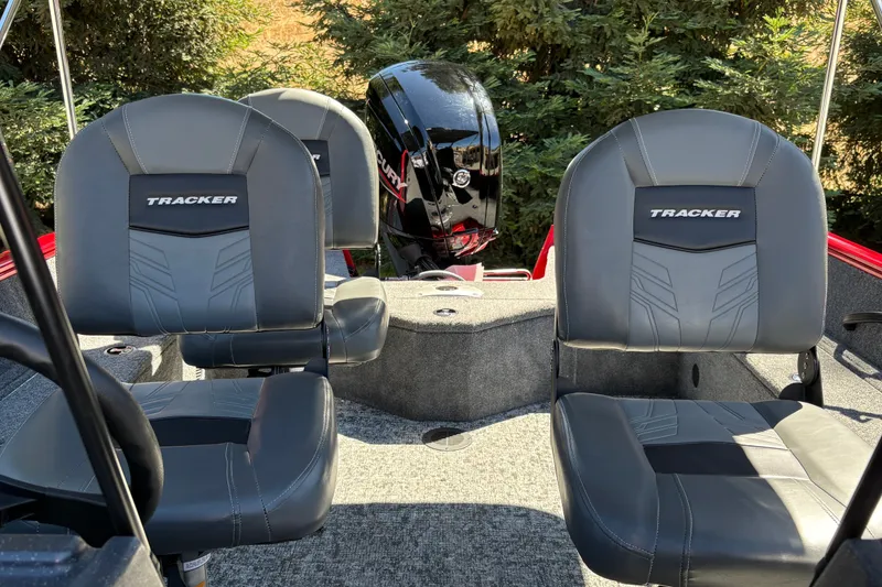 Slide: The Image of 2026 Tracker Pro Guide V-16 WT boat interior with gray seats and motor. - 17