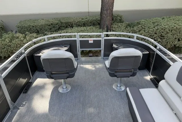 Slide: The Image of 2026 Sun Tracker Fishin' Barge 22 DLX with two swivel seats on deck. - 12