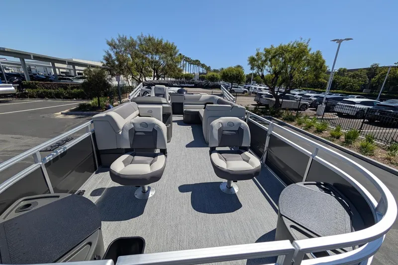 Slide: The Image of 2026 Sun Tracker Fishin' Barge 22 DLX pontoon boat with spacious seating and modern design. - 2