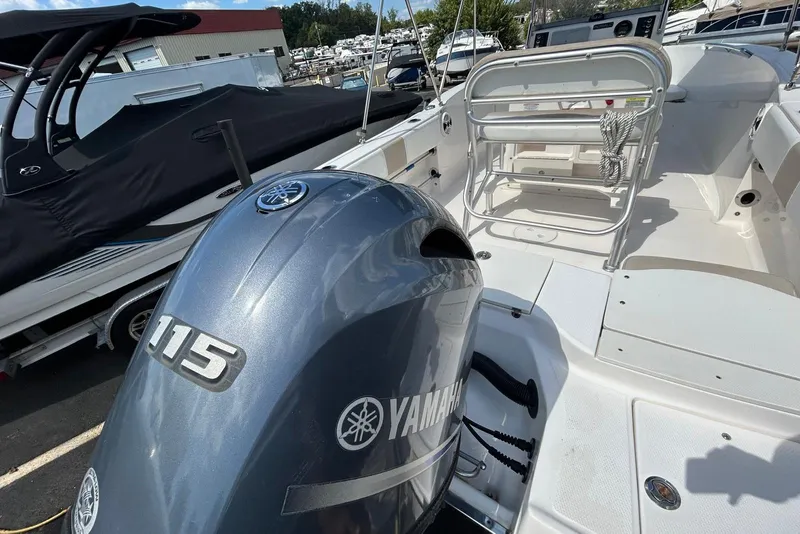 Slide: The Image of 2020 Robalo R180 Center Console boat with Yamaha 115 engine, docked outdoors. - 1