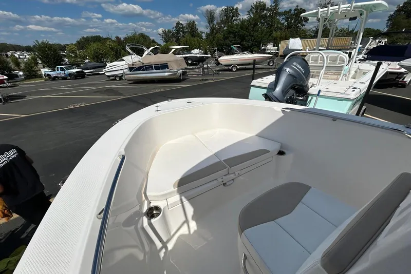 Slide: The Image of 2020 Robalo R180 Center Console boat with seating, parked in a marina. - 5