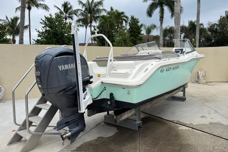 Slide: The Image of 2022 Key West 239 DFS boat with Yamaha engine, parked on a concrete surface. - 12