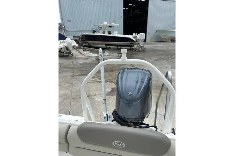 Slide: The Image of 2022 Key West 239 DFS boat with Yamaha outboard motor in a marina setting. - 16