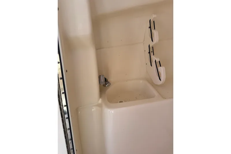 Slide: The Image of 2022 Key West 239 DFS boat interior with sink and storage hooks. - 22