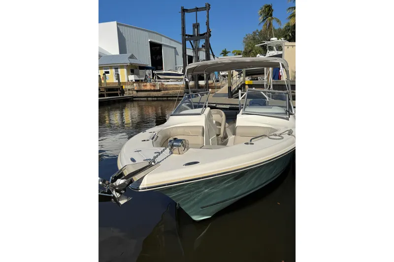 Slide: The Image of 2022 Key West 239 DFS boat docked near marina with clear blue sky. - 3