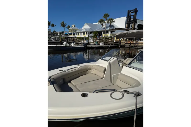 Slide: The Image of 2022 Key West 239 DFS boat docked at a marina with waterfront buildings. - 4