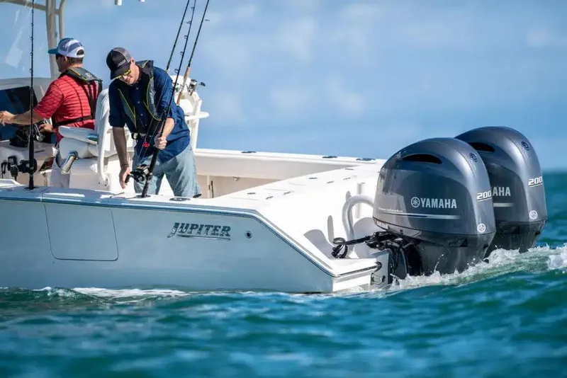 Slide: The Image of Manufacturer Provided Image: Two people fishing on a 2026 Jupiter 26 boat with Yamaha engines. - 2