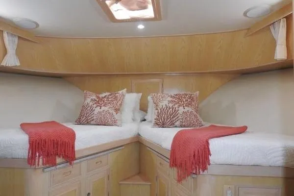 Slide: The Image of Luxurious 1998 Ocean Alexander Yachtfish Command Bridge cabin with twin beds and coral-themed decor. - 14