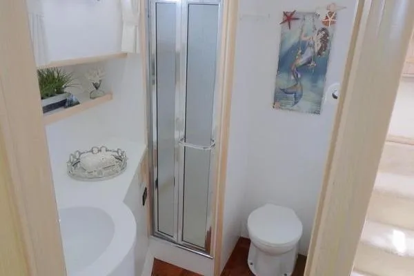 Slide: The Image of Bathroom interior of 1998 Ocean Alexander Yachtfish Command Bridge with shower and nautical decor. - 15
