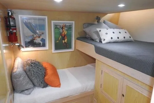 Slide: The Image of Cozy 1998 Ocean Alexander Yachtfish Command Bridge cabin with bunk beds and nautical decor. - 16