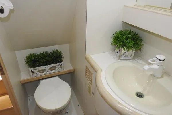 Slide: The Image of Bathroom interior of 1998 Ocean Alexander Yachtfish Command Bridge with sink and decorative plants. - 17