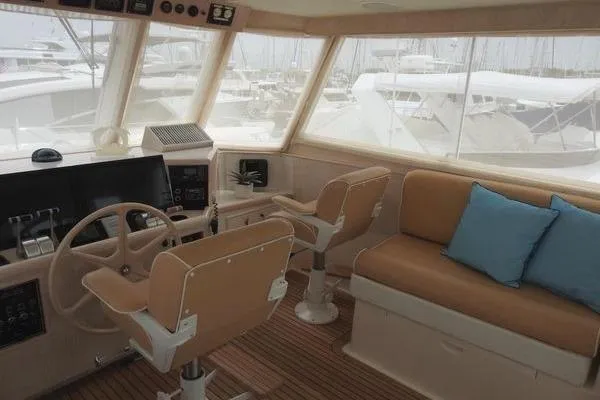 Slide: The Image of 1998 Ocean Alexander Yachtfish Command Bridge interior with helm, seating, and marina view. - 18