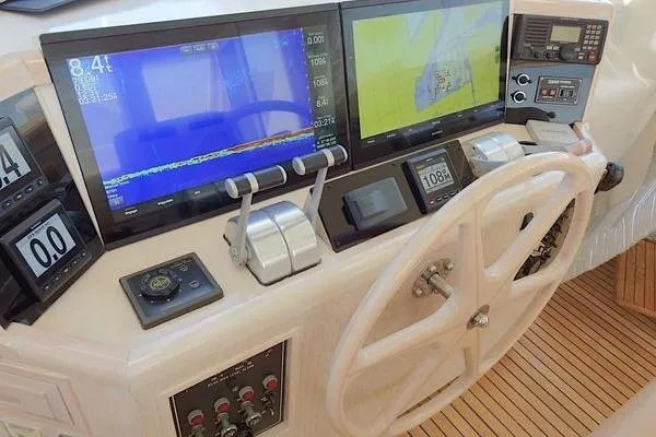 Slide: The Image of 1998 Ocean Alexander Yachtfish Command Bridge helm with navigation screens and controls. - 20