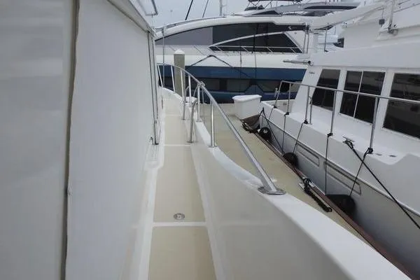 Slide: The Image of 1998 Ocean Alexander Yachtfish Command Bridge, side deck view with railing and neighboring boats. - 22