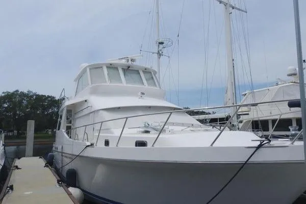 Slide: The Image of 1998 Ocean Alexander Yachtfish Command Bridge docked at marina, showcasing sleek design. - 26