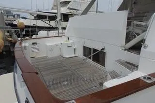 Slide: The Image of 1998 Ocean Alexander Yachtfish Command Bridge with spacious deck and elegant wood finish. - 3