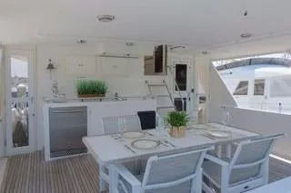 Slide: The Image of 1998 Ocean Alexander Yachtfish Command Bridge with elegant outdoor dining area. - 4