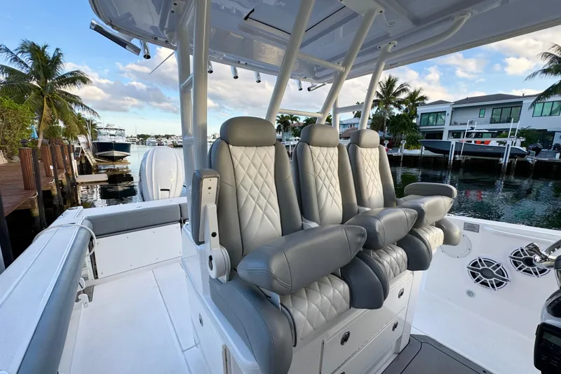 Slide: The Image of 2021 Everglades 335 Center Console boat interior with seating and rod holders. - 14