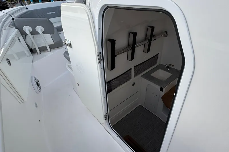 Slide: The Image of 2021 Everglades 335 Center Console boat interior with modern dashboard and waterfront view. - 19
